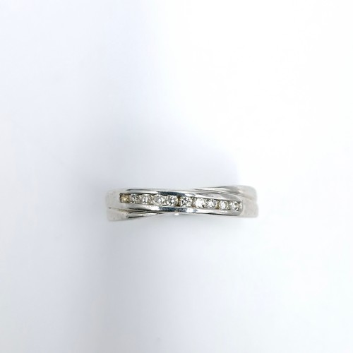 10 - A nine carat white gold ring set with diamond band of 0.15 carats marked to band. Ring size - N. Wei... 