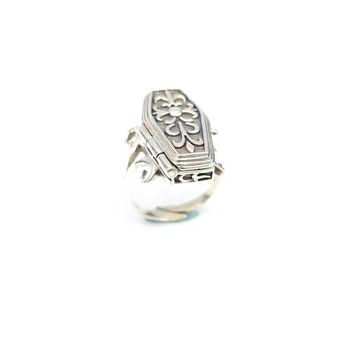 11 - Star Lot : An interesting sterling silver coffin ring with a hinged coffin mount housing a skeleton.... 