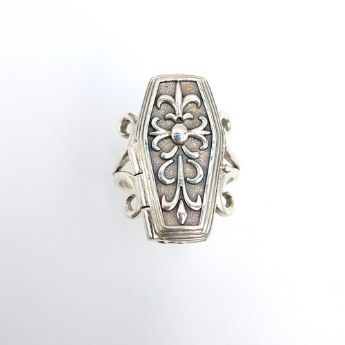 11 - Star Lot : An interesting sterling silver coffin ring with a hinged coffin mount housing a skeleton.... 