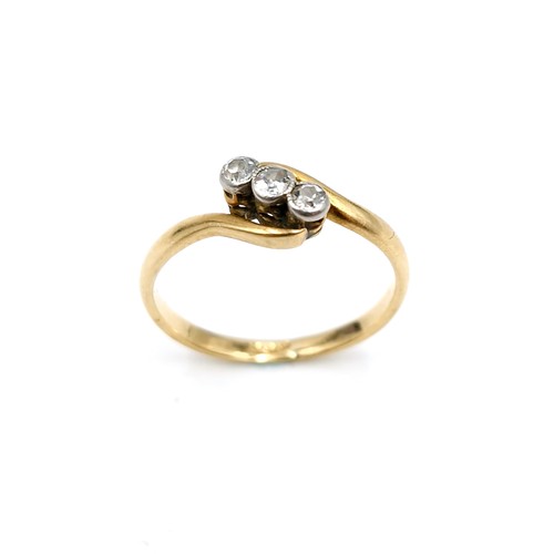 15 - Star Lot : An 18 carat gold ring set with three diamonds on a twist mount. Ring size - L. Weight - 1... 