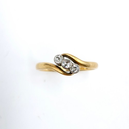 15 - Star Lot : An 18 carat gold ring set with three diamonds on a twist mount. Ring size - L. Weight - 1... 