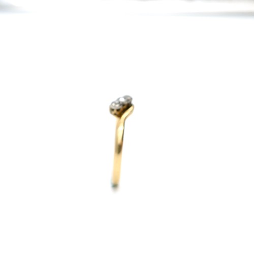 15 - Star Lot : An 18 carat gold ring set with three diamonds on a twist mount. Ring size - L. Weight - 1... 