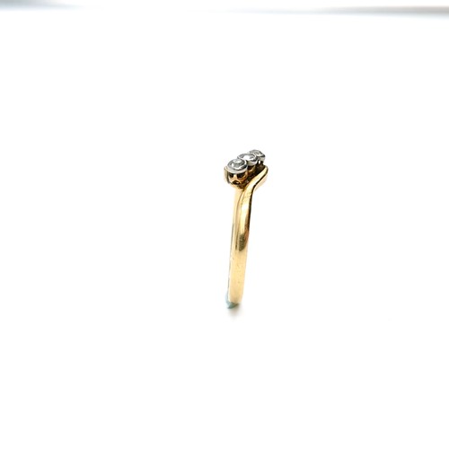 15 - Star Lot : An 18 carat gold ring set with three diamonds on a twist mount. Ring size - L. Weight - 1... 