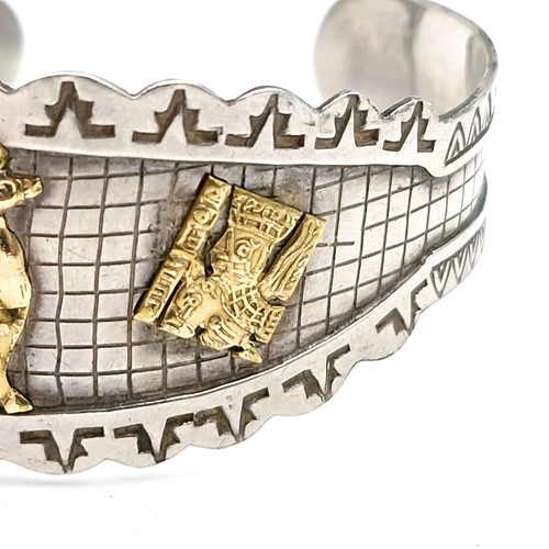 48 - A pretty sterling silver cuff bracelet with inlaid gold motifs and safety chain. Total weight 20 gra... 