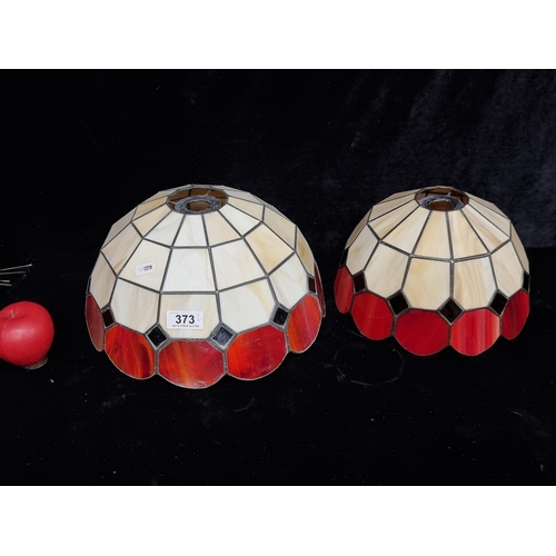 373 - A pair of Tiffany style stained glass lamp shades. Both in good condition.