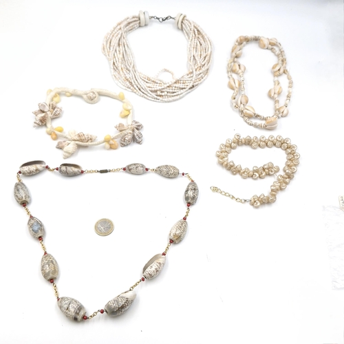 533 - Five sea shell necklaces including some examples with conch shells.