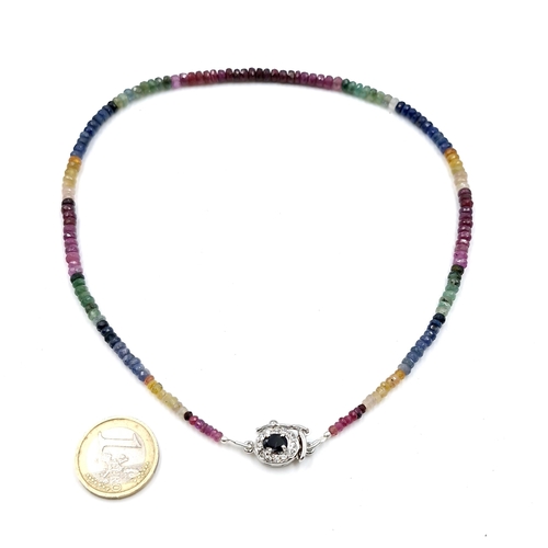 567 - A super example of a graduated 120cts multi stone gemstone necklace set with rubys, sapphires, and e... 