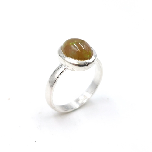 573 - An Ethiopian opal stone ring approx. 4cts, set in sterling silver stamped 925. Ring size Q. Weight 3... 