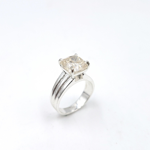 593 - A 4.40ct cushion cut white moissanite stone ring set in sterling sliver stamped 925. Ring size R. To... 