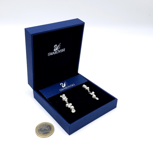 595 - A pair of brand new Swarovski Crystal pearl pendant earrings. Housed in original box with certificat... 