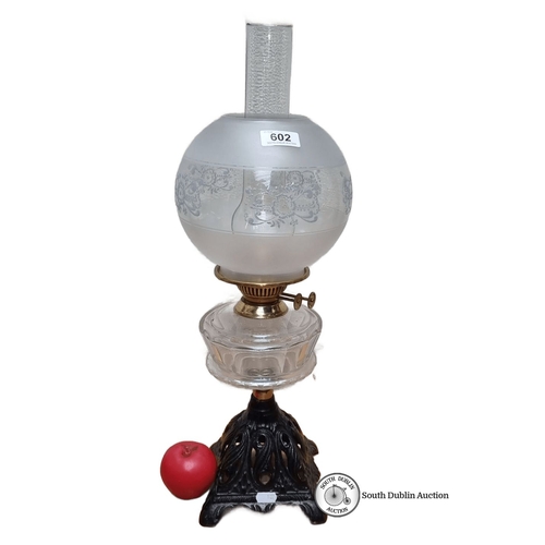 602 - Star Lot : A beautiful Victorian glass oil lamp with ornate metal base, featuring a frosted globe sh... 