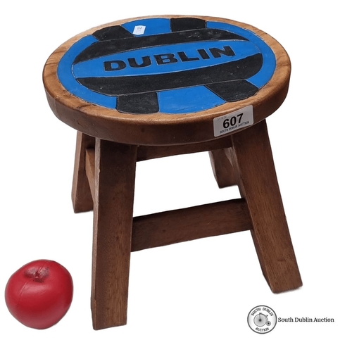 607 - Wooden stool featuring a painted Dublin motif. Compact, rustic design with sturdy legs.