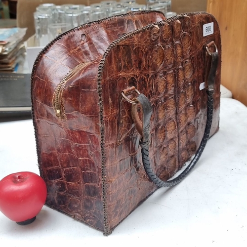 608 - Vintage crocodile leather handbag with top handles and zip closure, featuring a rich brown patina.