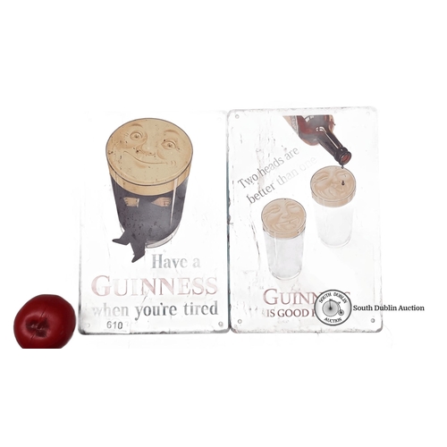 610 - Pair of vintage Guinness tin signs with classic advertising slogans and iconic stout imagery.