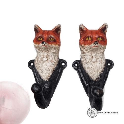 613 - Pair of vintage cast iron heavy fox head wall hooks, featuring hand-painted detail.