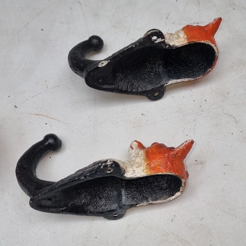 613 - Pair of vintage cast iron heavy fox head wall hooks, featuring hand-painted detail.