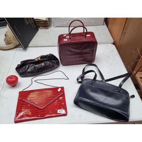 617 - Collection of four vintage handbags, featuring various styles and textures. Includes an Estée Lauder... 