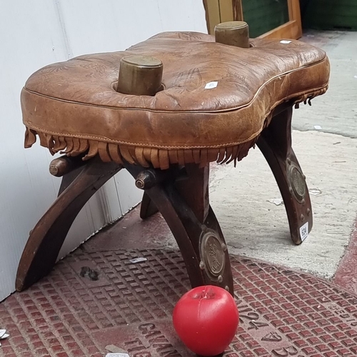 624 - Leather Camel stool with embossed designs labeled 