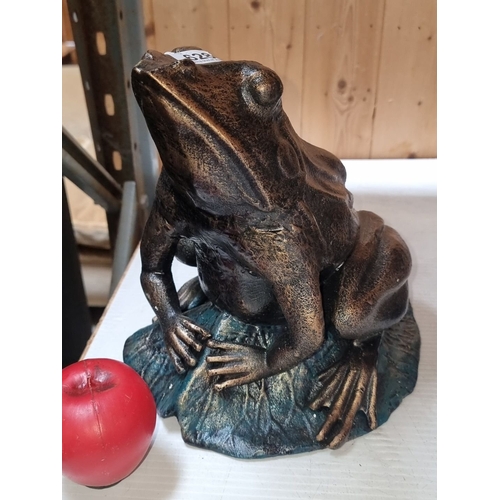 628 - A large heavy Bronzed  frog sculpture on a leaf base with patina finish.