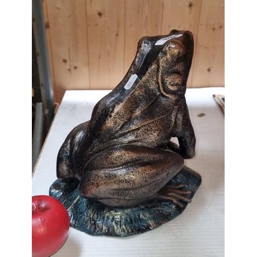 628 - A large heavy Bronzed  frog sculpture on a leaf base with patina finish.