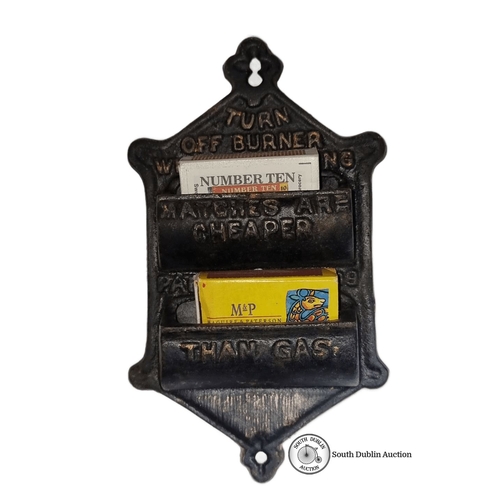 632 - Antique cast iron match holder featuring advertising slogan. Vintage design with compartments for ma... 