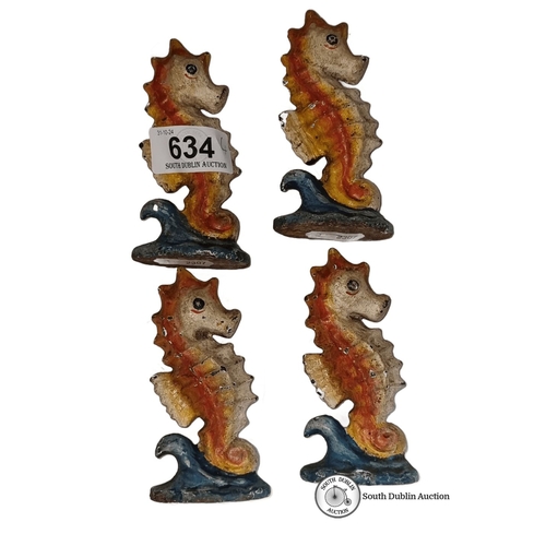 634 - Set of four vintage seahorse cast iron figures with colorful painted finish, featuring orange and bl... 