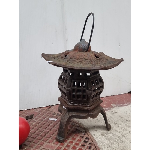 641 - Vintage cast iron lantern with intricate lattice design and curved roof. Rust patina enhances antiqu... 