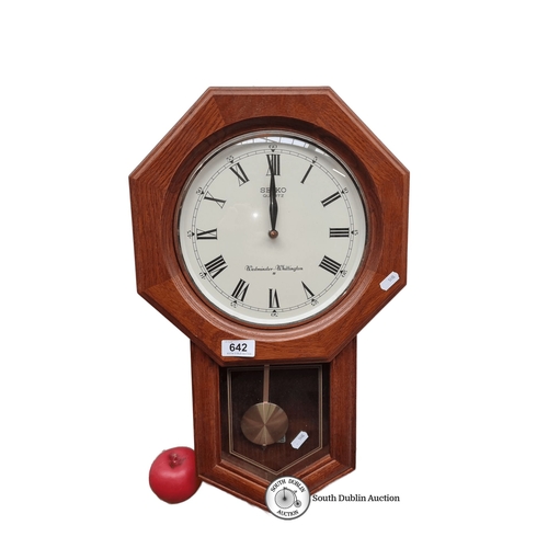 642 - Seiko quartz wall clock features Westminster-Whittington chimes, a wooden octagonal case, and a Roma... 