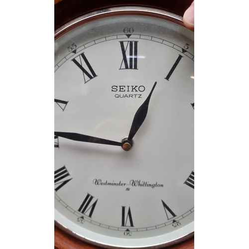 642 - Seiko quartz wall clock features Westminster-Whittington chimes, a wooden octagonal case, and a Roma... 