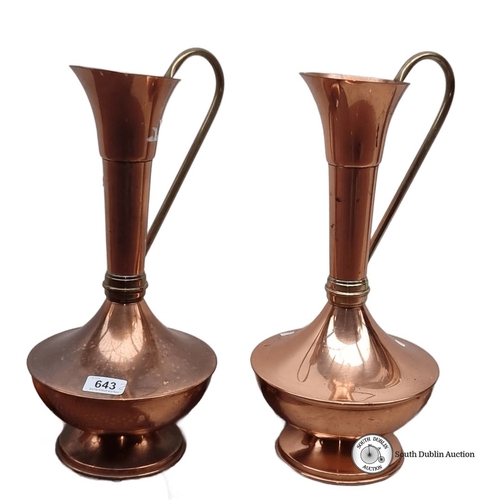 643 - Pair of vintage copper ewers with brass handles, featuring sleek, elongated necks with a flared open... 