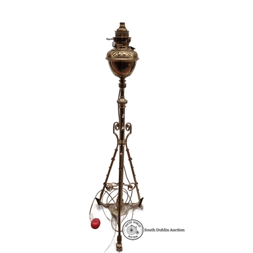 649 - Brass oil lamp with tripod stand, featuring ornate detailing and 