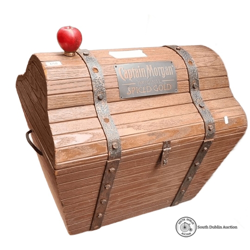 658 - A Large Wooden treasure chest with Captain Morgan branding, featuring metal straps and a hinged lid.... 