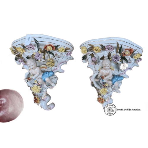 690 - Pair of porcelain wall sconces featuring cherubs and floral motifs, hand-painted in vibrant colors. ... 