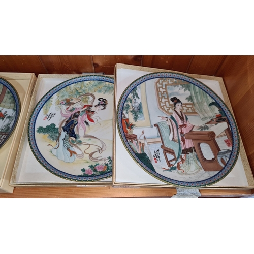 693 - Set of four decorative porcelain plates with intricate Chinese-style artwork depicting elegant figur... 