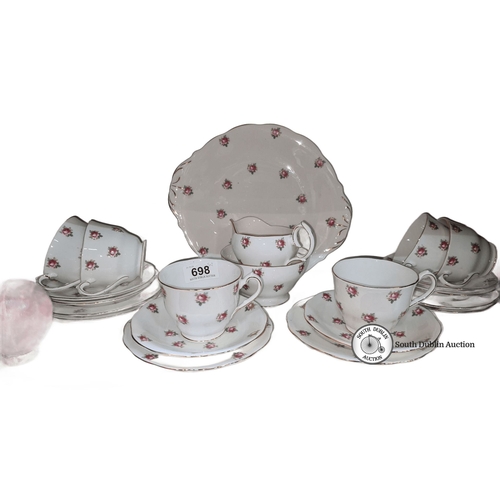 698 - Fine bone china tea set with floral motif from England. Includes teacups, saucers, and serving piece... 