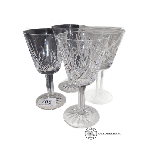 705 - Set of four Waterford crystal wine glasses, featuring intricate cut patterns and brand etching on th... 