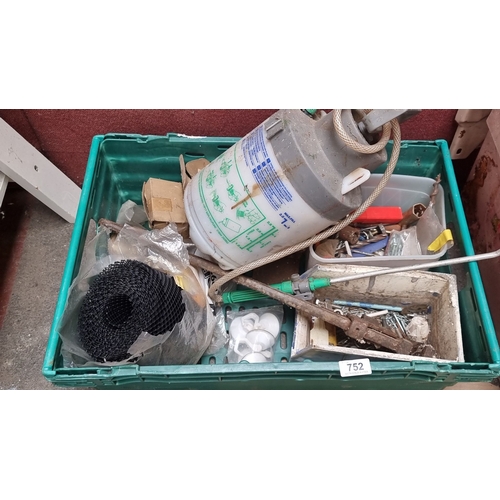 752 - Mixed lot of assorted tools, hardware, and a Hozelock garden sprayer in a green plastic crate. These... 