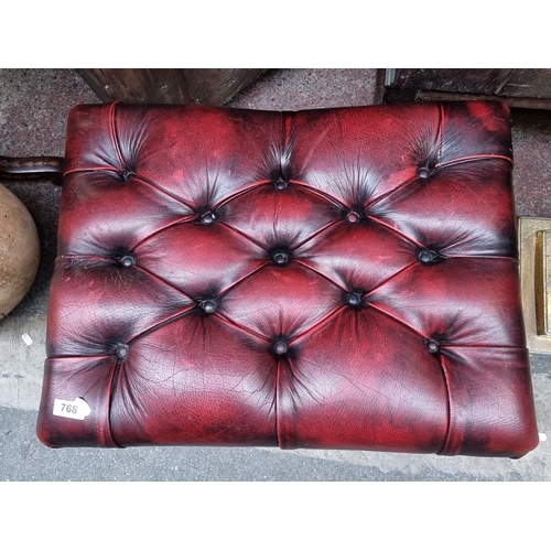 768 - Victorian-style tufted Chesterfield  footstool has mahogany legs and is upholstered in rich red leat... 