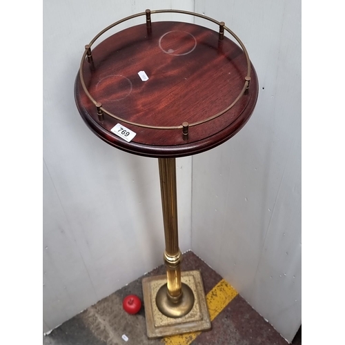 769 - Victorian style mahogany and brass pedestal stand with a fluted column and a circular top with a gal... 