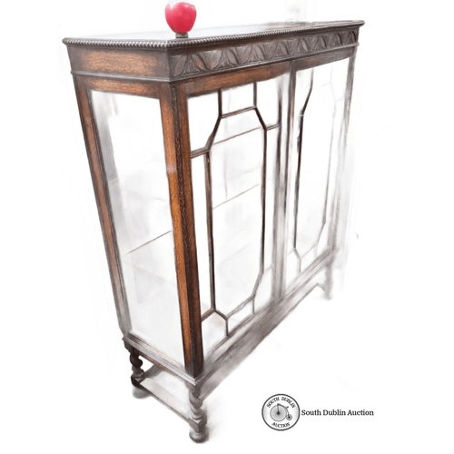 777 - Star Lot : Edwardian mahogany display cabinet with carved details, glazed doors, and turned legs. In... 