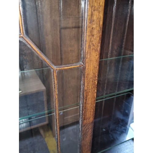 777 - Star Lot : Edwardian mahogany display cabinet with carved details, glazed doors, and turned legs. In... 