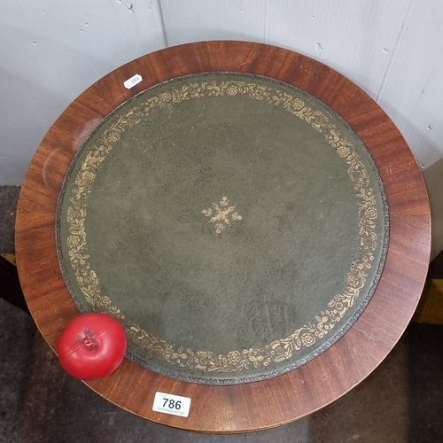 786 - Mahogany drum table with green leather inset top and decorative gold tooling, from the early 20th ce... 