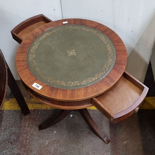 786 - Mahogany drum table with green leather inset top and decorative gold tooling, from the early 20th ce... 