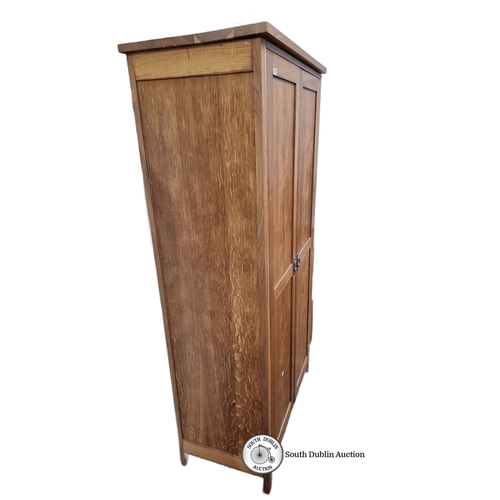 797 - An Oak two door wardrobe, featuring a two-door design and spacious interior shelving.