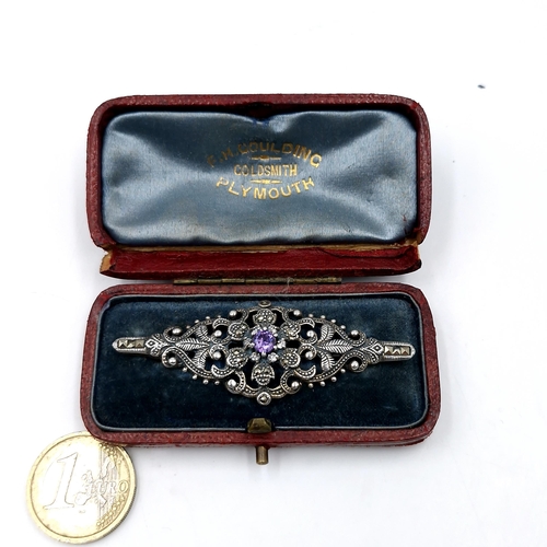 61 - An outstanding antique silver brooch with amethyst central stone with marcasite cut detailing. Dimen... 