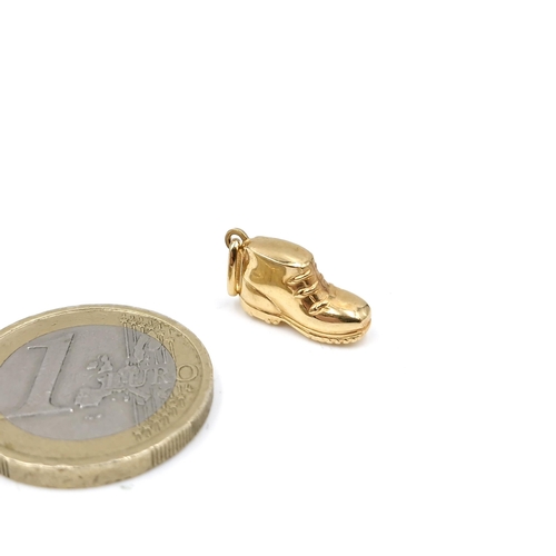 63 - An 18 carat gold charm in the form of a boot. Weight - 1.09 grams.