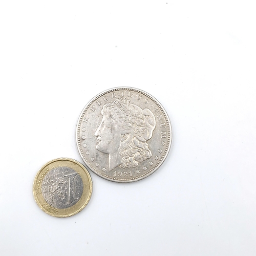 69 - A Morgan silver dollar coin dated 1921. Weight - 26.73 grams.