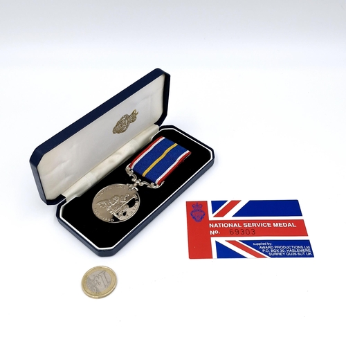 71 - A boxed UK national service medal no. 69303 with original box.