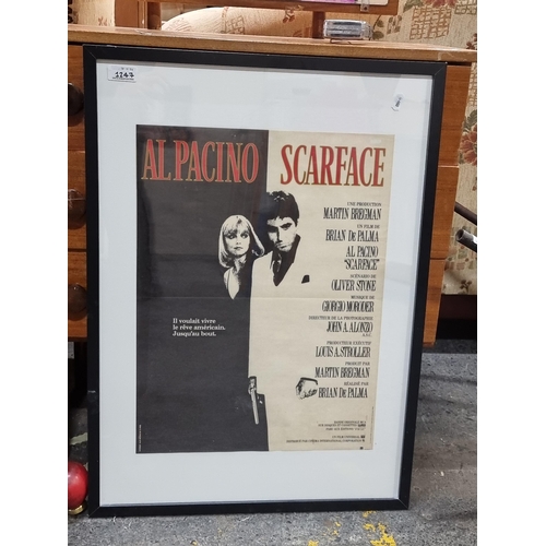 1247 - A print of a Film Poster. Features 'Al Pacino Scarface'. Housed in a black frame behind glass.