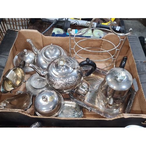 1079 - A box of antique Silver-plated items including teapots, creamers, sugar bowl, and serving tray. Feat... 